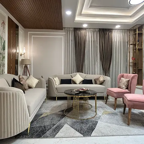 Living room with a botanical mural wallpaper feature wall, wood-clad cove ceiling, marble-and-brass TV wall