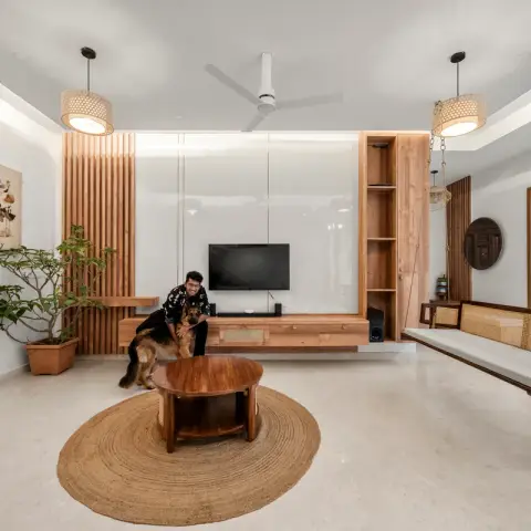 Living room with a cane-backed teak jhoola hung on brass chains along the right wall