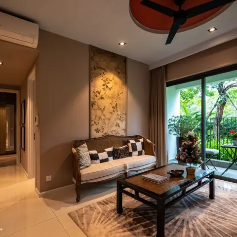 Living room with a cane-frame settee in checkered cushions, a dark wood coffee table on a patterned rug