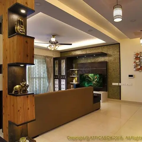 Living room with a carved wood display partition holding brass decor pieces, a green-textured TV feature wall