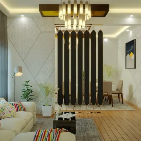 Living room with a cream sofa styled in colourful geometric cushions, facing a fin-slat black room divider under a linear pendant chandelier that opens into