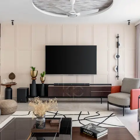 Living room with a cream wall-panelled TV backdrop, dark wood floating console, houndstooth-and-rust swivel armchairs around a black coffee table on an