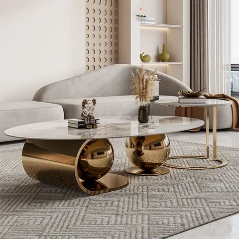 Living room with a curved beige sofa, a scalloped circle-relief accent wall, and an oval marble coffee table on a gold cylindrical base