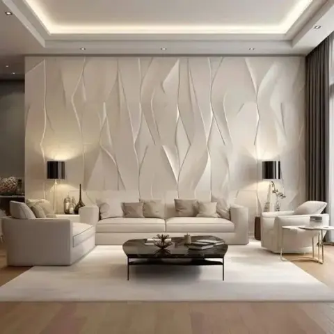 Living room with a dramatic 3D faceted blade-pattern wall panel flanked by matching black table lamps behind a white sectional sofa and black glass coffee table