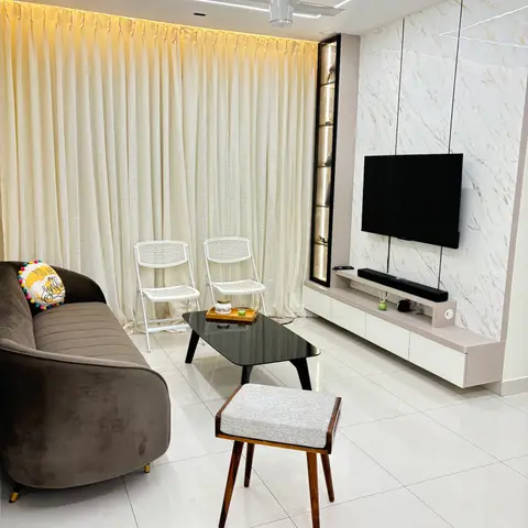 Living room with a floor-to-ceiling cream curtain wall, a marble-clad TV feature wall with a floating cabinet