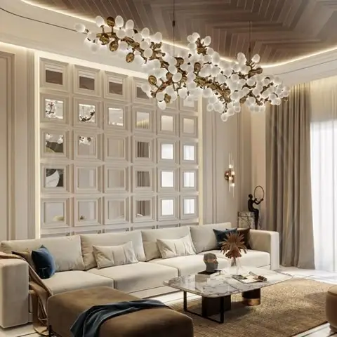 Living room with a floor-to-ceiling mirrored grid panel wall, a branching gold pendant chandelier, and a beige sectional sofa facing a marble-top coffee table.