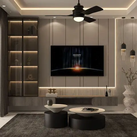 Living room with a fluted-panel TV wall lit by a warm profile strip, a backlit glass-front display cabinet beside it, twin dome pendants