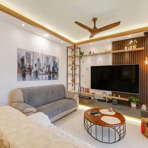 Living room with a fluted walnut TV feature wall, cluster bulb pendant lighting, a cove-lit tray ceiling, a black ladder display shelf