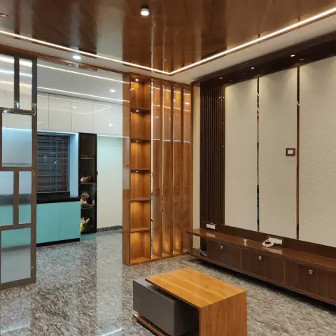 Living room with a glossy wood-clad cove-lit ceiling, a fluted wood display partition, a TV unit wall with textured wallpaper panels, and a wood coffee table