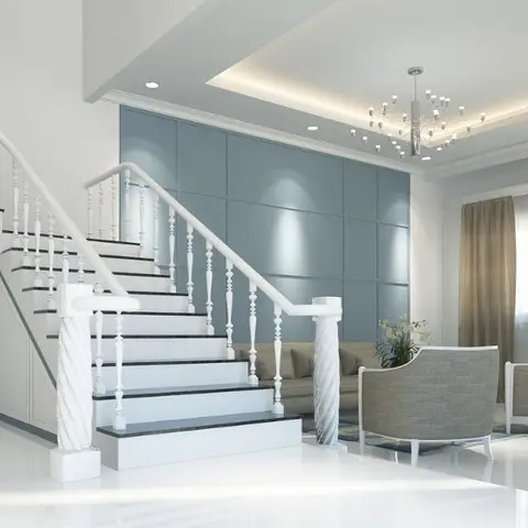 Living room with a grand white staircase with twisted baluster spindles, a blue-grey panelled feature wall, and a beaded chandelier over a grey sofa set.