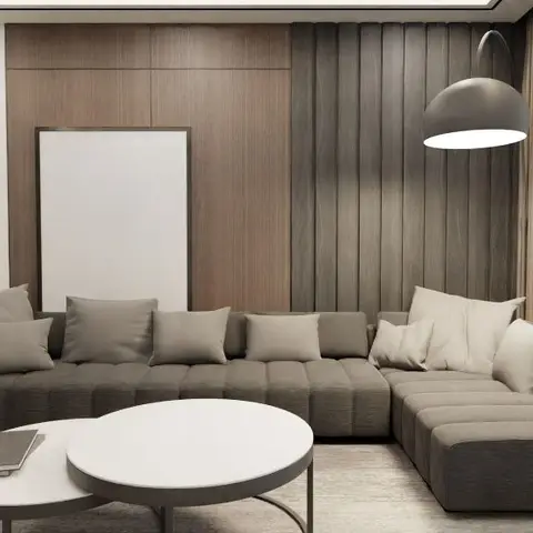 Living room with a large L-shaped charcoal sectional sofa, mixed-tone wood slat wall panelling, a black dome floor lamp and round nesting coffee tables.