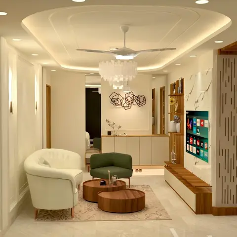 Living room with a layered cove-lit false ceiling, fluted TV wall panelling, and cream and olive-green accent armchairs around nested round coffee tables.