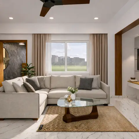 Living room with a light grey L-shaped sofa facing a wall-mounted TV in a lit recessed niche, a glass-and-wood coffee table on a jute rug