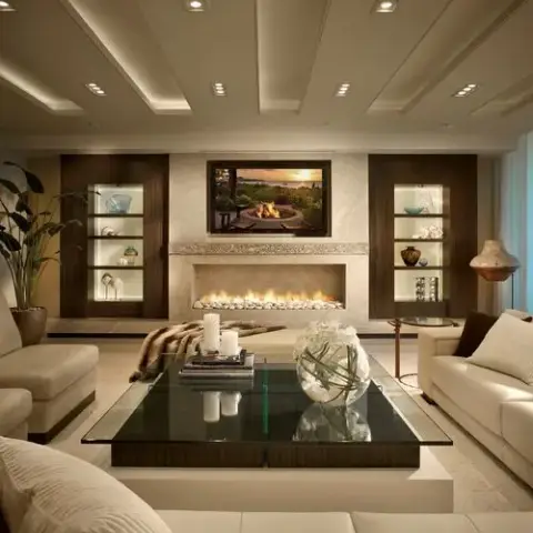 Living room with a linear gas fireplace beneath a wall-mounted TV, flanked by dark wood display alcoves with glass shelving