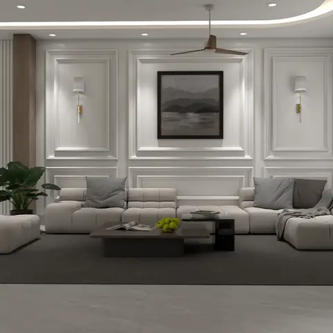 Living room with a low beige modular sectional sofa on a dark rug facing a white moulded-panel wall with brass wall sconces flanking a framed landscape print