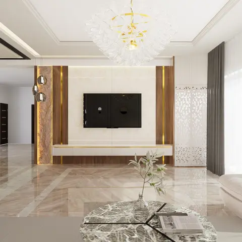 Living room with a marble-and-gold TV feature wall flanked by wood fluting, a white jaali screen door, and a statement crystal chandelier above a marble floor