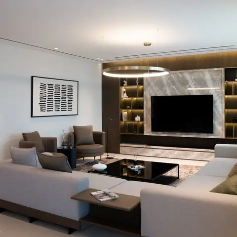 Living room with a marble-clad TV feature wall lined with backlit display niches, dark wood veneer joinery