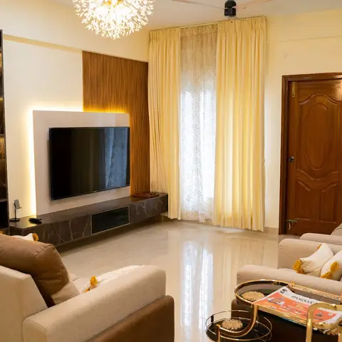 Living room with a marble-clad TV unit flanked by a backlit wood fluted panel and a dark stone display shelf