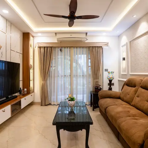 Living room with a marble-clad TV feature wall, a wood veneer display cabinet, a carved wood-and-glass coffee table