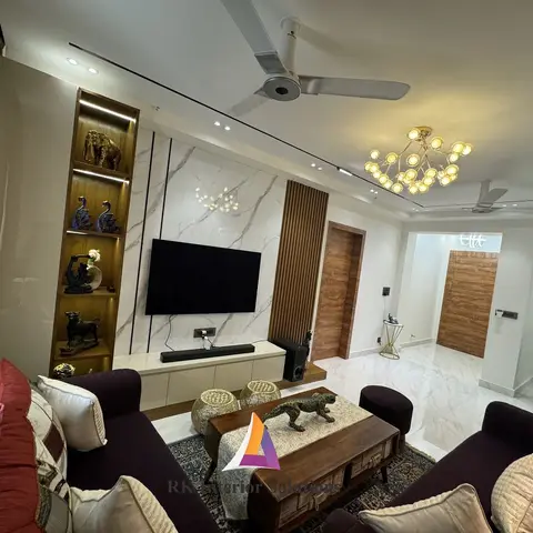 Living room with a marble-clad TV feature wall accented by a vertical wood fluted strip, a backlit curio display shelf