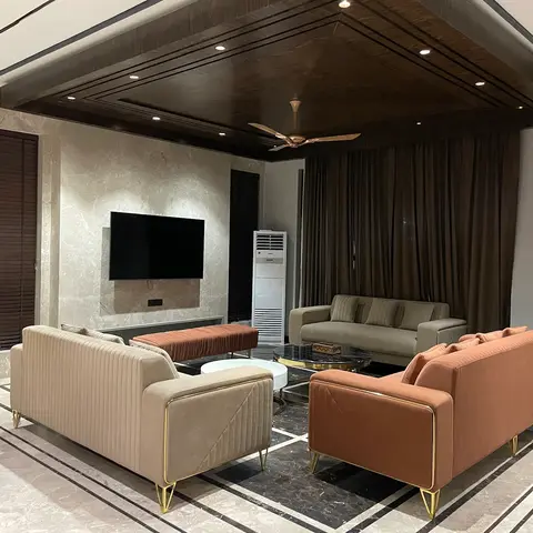 Living room with a marble-clad TV feature wall, a dark wood coffered ceiling with recessed downlights