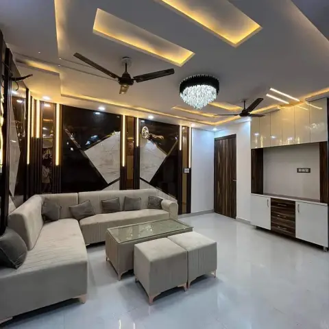 Living room with a multi-tier cove-lit POP ceiling, a faceted crystal pendant light, a dark marble and mirror geometric feature wall