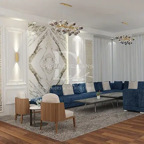 Living room with a navy velvet sectional sofa facing a marble diamond-inlay feature wall flanked by gold-trimmed geometric panels