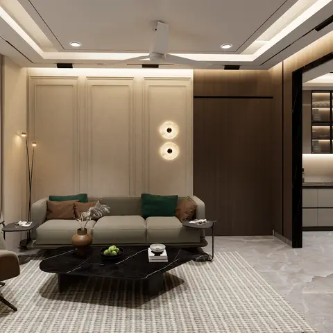 Living room with a panelled accent wall and round wall sconces behind a sage sofa, a black marble coffee table on a striped rug
