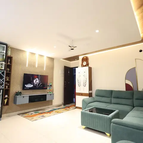 Living room with a sage-green velvet L-shaped sofa, a black-and-wood bar display unit with a diamond wine rack