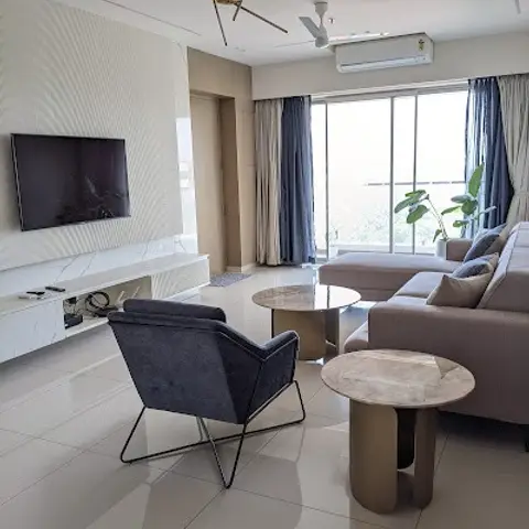 Living room with a sputnik-style gold pendant light, a textured wall panel behind a floating TV unit