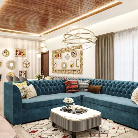 Living room with a teal tufted sectional sofa, a wood-panel ceiling with cove lighting, an orbital chandelier