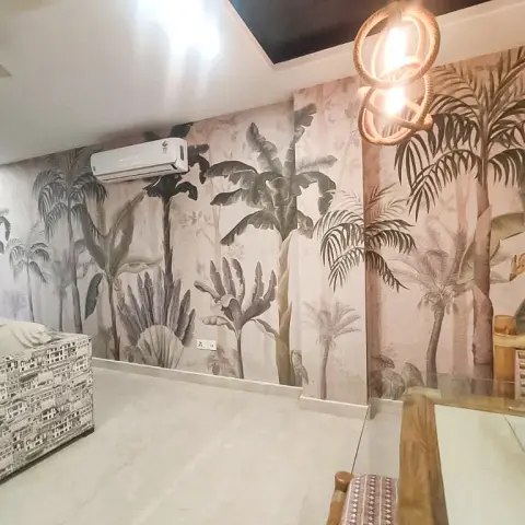 Living room with a tropical palm-leaf mural wallpaper wall, a rope-wrapped rattan pendant light, and a patterned print sofa.