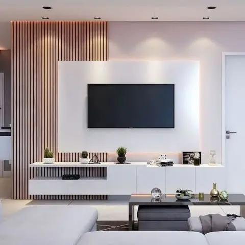 Living room with a vertical fluted-wood accent wall behind a backlit white TV console styled with plants and decor.