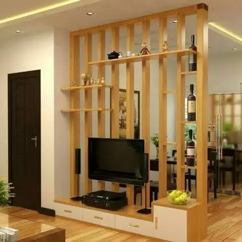 Living room with a wood-slat room-divider unit doubling as a TV console and open display shelving, separating the space from the dining and kitchen behind.