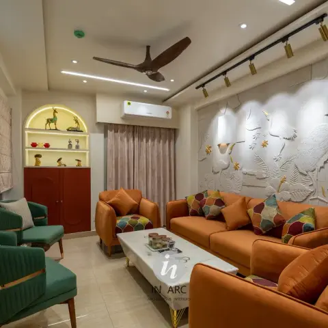 Living room with burnt-orange velvet sofas and green velvet armchairs facing a marble coffee table