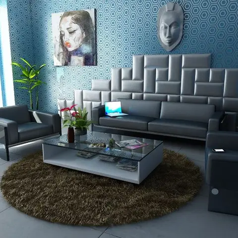 Living room with dark grey tufted leather sofas around a glass coffee table on a round shag rug
