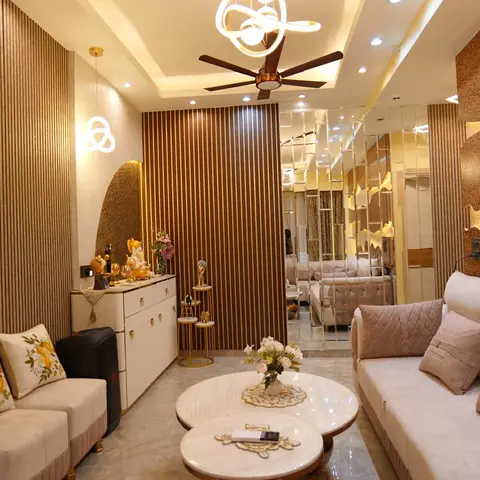 Living room with fluted wood panelling, a textured wave-patterned gold accent wall, a quilted beige sofa