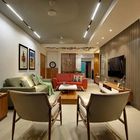 Living room with olive and burnt-orange sofas facing mid-century wood-frame armchairs, a wood-slat TV wall