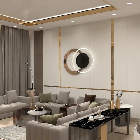Living room with three beige channel-tufted sofas arranged around a round rose-gold coffee table and black marble console