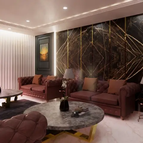 Living room with tufted burgundy leather chesterfield sofas around round gold-base marble coffee tables