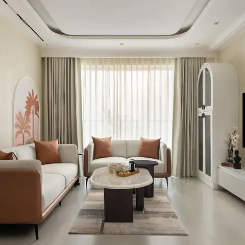 Living room with two tan-leather-trimmed sofas facing a stone-top coffee table, palm-print art panels on the accent wall, sage green layered curtains