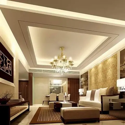 Long beige living room under a three-tier stepped POP ceiling with cove lighting and a gold crystal chandelier