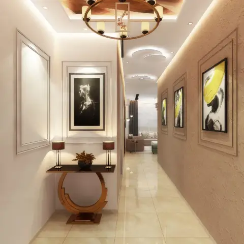 Long entrance corridor with textured feature wall, framed art triptych, and a round brass-legged console table under a circular chandelier ring.