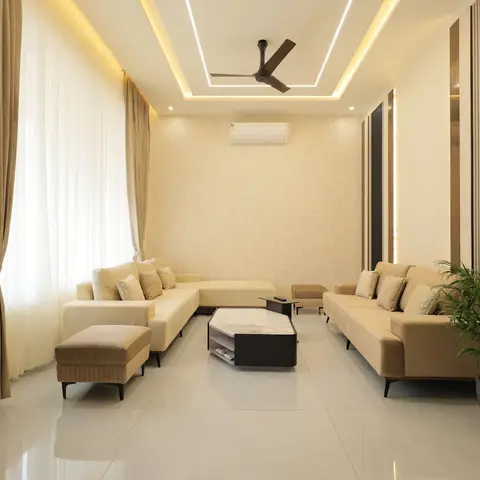 Long formal living room with a cove-lit rectangular false-ceiling frame, floral-textured wallpaper feature wall, vertical fluted panelling on the side wall