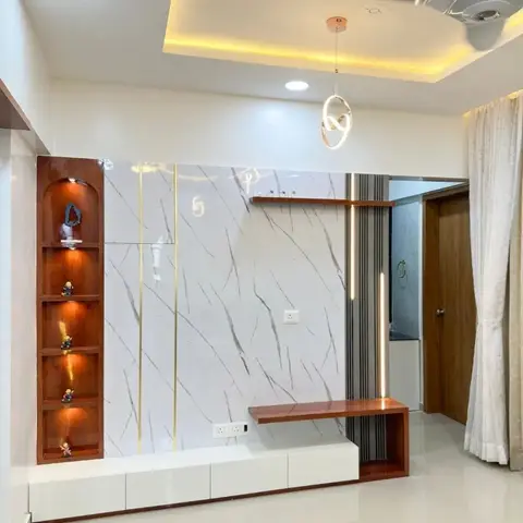 Marble slab feature wall with brass inlay strips, a wood-lit display niche and a floating TV console under a cove-lit ceiling.