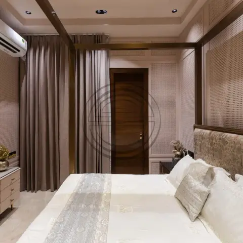 Master bedroom lined floor to ceiling in beige CNC-perforated panelling divided by brass inlay strips