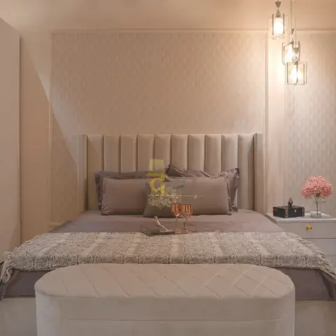 Master bedroom render with a tall channel-tufted beige headboard flanked by geometric wallpaper panels, a diamond-tufted bench at the foot of the bed