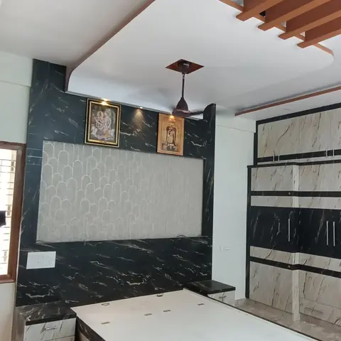 Master bedroom with a black-and-white marble-effect headboard wall featuring a textured arch-pattern insert panel, a matching two-tone marble-finish wardrobe