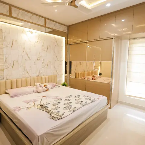 Master bedroom with a channel-tufted cream headboard against a marble-clad accent wall