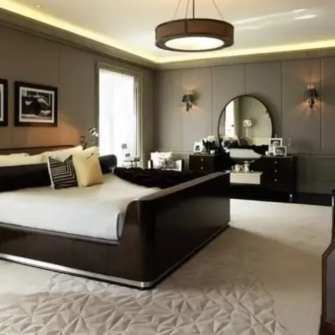 Master bedroom with a dark wood sleigh bed, grey wall panelling, and a drum pendant light under cove ceiling lighting.